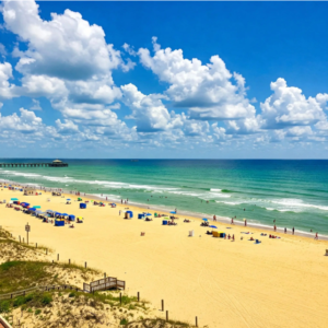Galveston Island Historic Pleasure Pier with beachgoers enjoying rides and oceanfront boardwalk attractions.