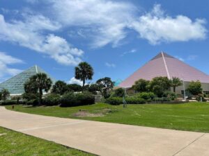 Moody Gardens pyramids surrounded by palm trees and reflecting pools in Galveston Island.